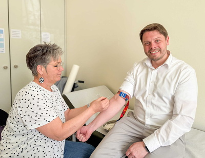 Designierter Landrat Björn Bartels bekommt für einen HIV-Test Blut am Arm von Gesundheitsamtleiterin Dr. Regina Roloff abgenommen.