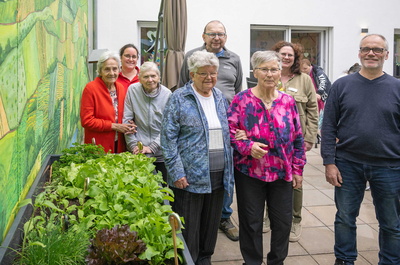 Menschen neben Hochbeet