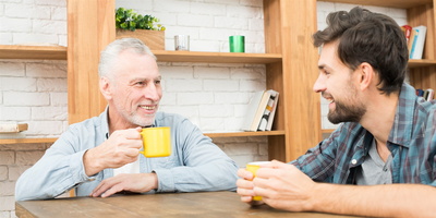 Senior und junger Mann im Gespräch