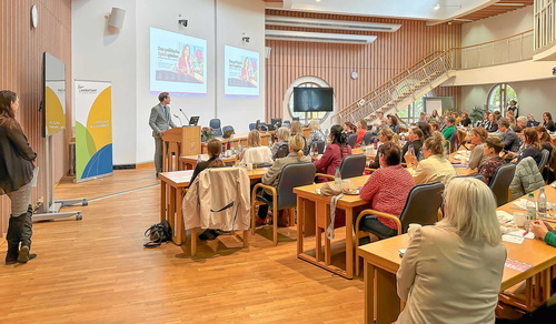 Teilnehmende beobachten die Präsentation