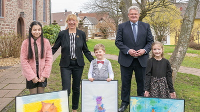 Drei Gewinnerkinder mit ihren gemalten Werken, der stellvertretender Landrätin Monika Wolf-Pleßmann und Eschaus Bürgermeister Gerhard Rüth